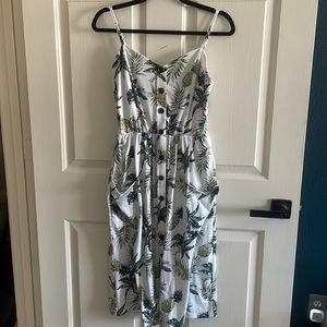 Summer pineapple and plan pull on dress. Features 2 external pockets.